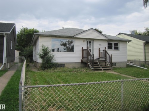 White siding exterior with a dark shingle roof - 9512 63 Avenue Nw, Edmonton, AB 