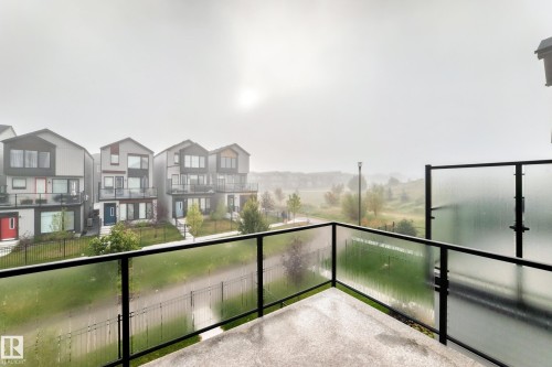 Private balcony featuring concrete flooring and a glass railing - 479 39 St Sw, Edmonton, AB 