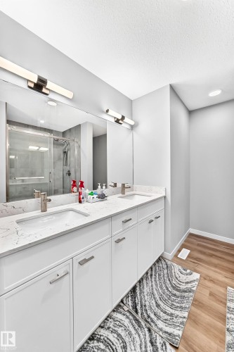 Double vanity with white cabinetry, integrated sinks, and polished chrome fixtures - 479 39 St Sw, Edmonton, AB 
