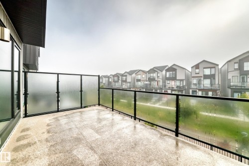 Outdoor balcony with glass panel railing and concrete flooring - 479 39 St Sw, Edmonton, AB 