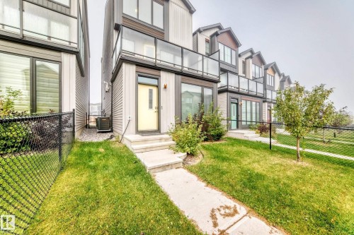 Modern exterior with light gray siding and dark trim - 479 39 St Sw, Edmonton, AB 