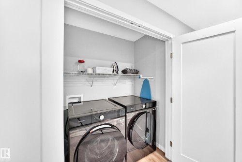 Dedicated laundry closet with shelving - 479 39 St Sw, Edmonton, AB 