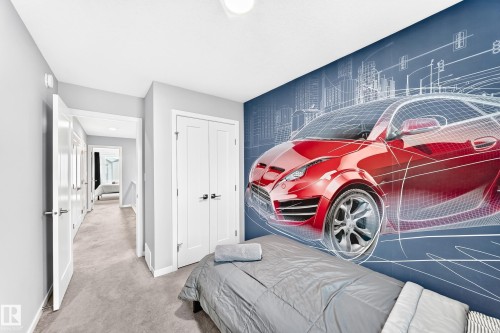 Spacious room with a decorative accent wall and plush carpet flooring - 479 39 St Sw, Edmonton, AB 