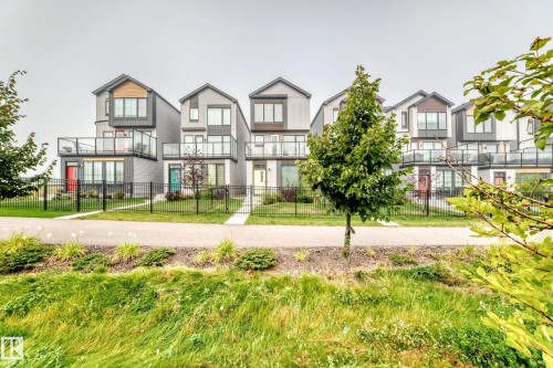 Modern multi-level townhomes with prominent balconies featuring glass railings and contrasting exterior finishes - 479 39 St Sw, Edmonton, AB 