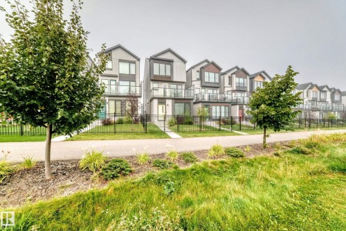 Modern exterior architecture with multiple balconies and integrated landscaping - 479 39 St Sw, Edmonton, AB 