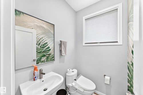 Modern wall-mounted sink with a polished chrome faucet - 479 39 St Sw, Edmonton, AB 