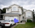 Stucco exterior with multiple gables and a multi-level roofline - 16503 68 Street Nw, Edmonton, AB 