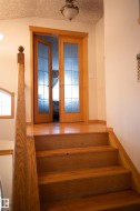 Hardwood staircase with matching wood flooring and railing - 