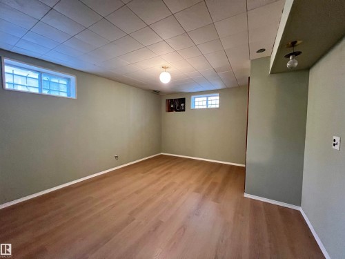 Recessed drop ceiling, wood-finish flooring, and multiple window openings - 15003 81 Street Nw, Edmonton, AB 