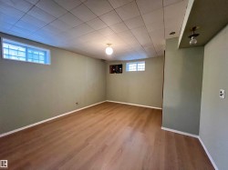 Recessed drop ceiling, wood-finish flooring, and multiple window openings - 