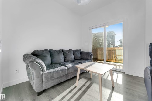 Sliding glass door, wood-finish flooring, and white walls - #62 2710 66 St Sw, Edmonton, AB 