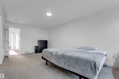 Plush carpet flooring, recessed ceiling lighting, and crisp white walls create a neutral palette - #62 2710 66 St Sw, Edmonton, AB 