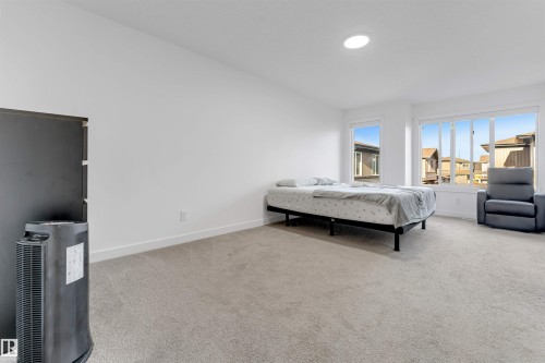 Recessed ceiling lighting, multiple large windows, and wall-to-wall carpeting - #62 2710 66 St Sw, Edmonton, AB 
