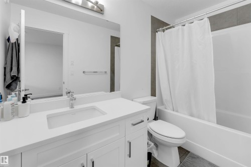 White vanity with integrated sink, chrome faucet, and white countertop - #62 2710 66 St Sw, Edmonton, AB 