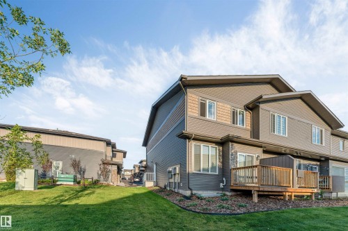 Multi-level siding exterior featuring stone accents and a wood deck - #62 2710 66 St Sw, Edmonton, AB 