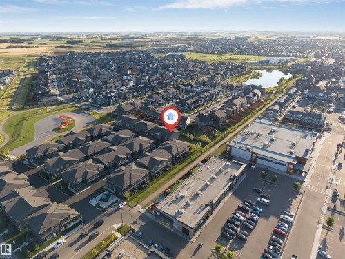 Aerial perspective of a residential community with a central recreational pond - #62 2710 66 St Sw, Edmonton, AB 