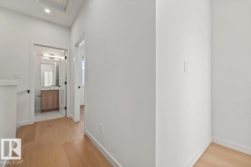 Wood-finish flooring throughout, white walls, and a recessed ceiling light - 15020 90 Avenue Northwest, Edmonton, AB 