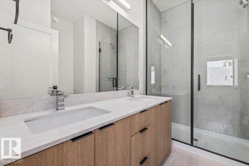 Dual vanity with wood-finish cabinetry and integrated sinks - 15020 90 Avenue Northwest, Edmonton, AB 