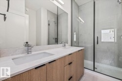 Dual vanity with wood-finish cabinetry and integrated sinks - 