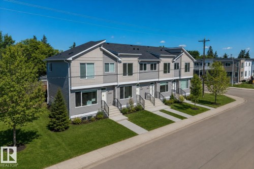 Modern townhome architecture featuring gabled rooflines, multi-toned siding, and dark-framed windows - 15020 90 Avenue Northwest, Edmonton, AB 