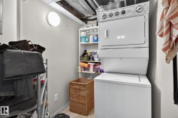 Dedicated laundry area featuring a stacked washer and dryer unit - 