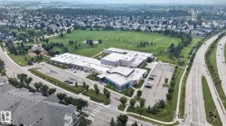 Aerial perspective showcasing a sprawling suburban neighborhood with extensive green spaces and established residential properties - 