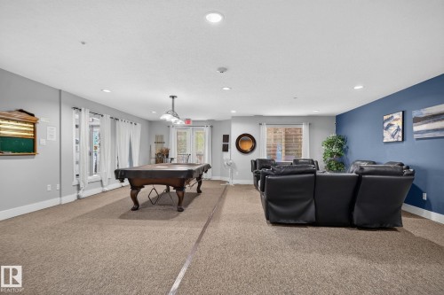 Spacious room with carpet flooring and recessed lighting - #335 2096 Blackmud Creek Dr Sw, Edmonton, AB - Indoor Photo Showing Other Room