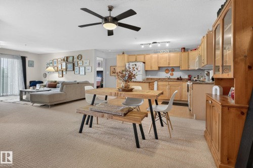 Open-concept interior featuring light-toned carpeting and neutral wall paint - #335 2096 Blackmud Creek Dr Sw, Edmonton, AB - Indoor