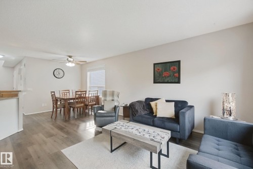 Open-concept living area featuring wood-finish flooring, a ceiling fan, and window blinds - 15618 141 Street Nw, Edmonton, AB 