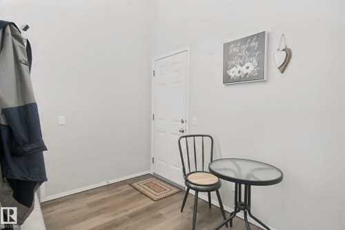 Recessed entry door with neutral painted walls and wood-finish flooring - 15618 141 Street Nw, Edmonton, AB 