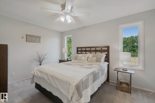 Carpeted flooring, white walls, and a ceiling fan with light fixture - 15618 141 Street Nw, Edmonton, AB 