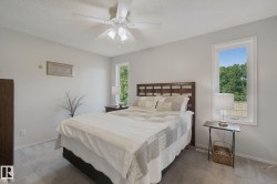 Carpeted flooring, white walls, and a ceiling fan with light fixture - 