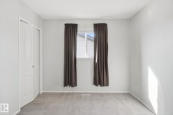 Recessed window, neutral wall paint, light-toned carpeting, and bi-fold closet doors - 