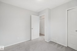 Plush carpeting, light-toned wall finishes, crisp white trim, and a white interior door - 