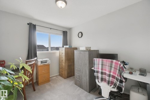 Neutral wall paint, ceiling-mounted light fixture, and a window with blinds - 15618 141 Street Nw, Edmonton, AB 