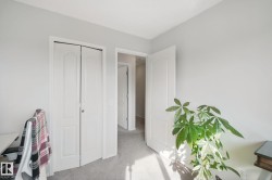 Light gray wall paint, white trim, white bi-fold closet doors, white interior doors, and gray carpet - 