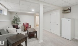 Recessed lighting, light-toned carpeting, a built-in window, a solid panel interior door, and wall-mounted shelving - 