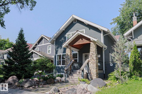 Craftsman-style exterior with dark siding and white trim - 10814 125 Street Nw, Edmonton, AB 