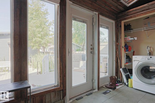 Laundry area with a built-in closet, wire shelving, and a large window - 10814 125 Street Nw, Edmonton, AB 