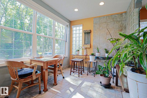Sunroom with expansive windows, recessed lighting, tile flooring, and a glass block window feature - 10814 125 Street Nw, Edmonton, AB 