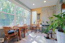 Sunroom with expansive windows, recessed lighting, tile flooring, and a glass block window feature - 10814 125 Street Nw, Edmonton, AB 