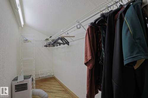 Wood-finish flooring with white walls and a sloped ceiling - 10814 125 Street Nw, Edmonton, AB 