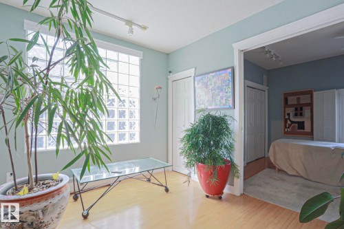 Wood-finish flooring with a glass block window and track lighting - 10814 125 Street Nw, Edmonton, AB 