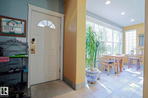 Entrance with paneled door and transom window, recessed ceiling lighting, and tiled flooring - 10814 125 Street Nw, Edmonton, AB 