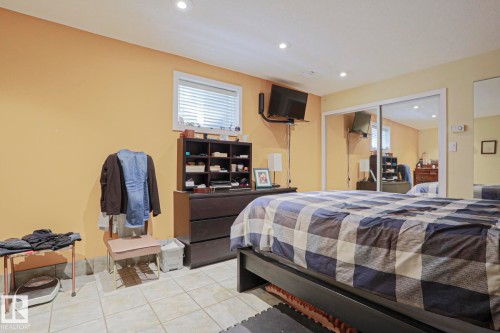 Recessed lighting, tile flooring, window with blinds, and mirrored sliding closet doors - 10814 125 Street Nw, Edmonton, AB 