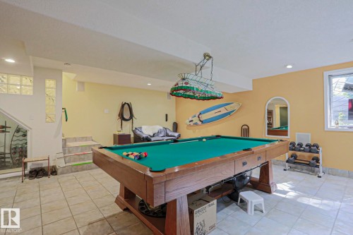 Recreation room featuring a wood-finish billiards table, tile flooring, recessed lighting, and a window with natural light - 10814 125 Street Nw, Edmonton, AB 