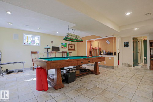 Recreation area featuring a built-in display niche, recessed lighting, and tile flooring - 10814 125 Street Nw, Edmonton, AB 