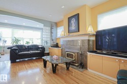 Hardwood flooring throughout, recessed ceiling lighting, built-in display shelving, and an arched entryway - 