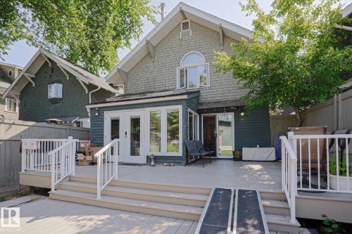 Expansive rear deck with multi-level stairs and white railings - 10814 125 Street Nw, Edmonton, AB 