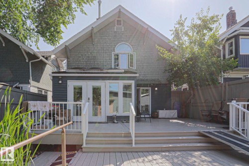 Expansive multi-level composite deck with white railings, featuring a ramp for access - 10814 125 Street Nw, Edmonton, AB 
